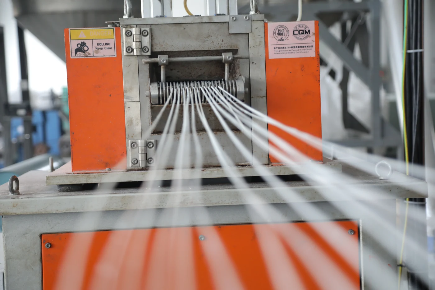 Extruded polyester strands on factory equipment