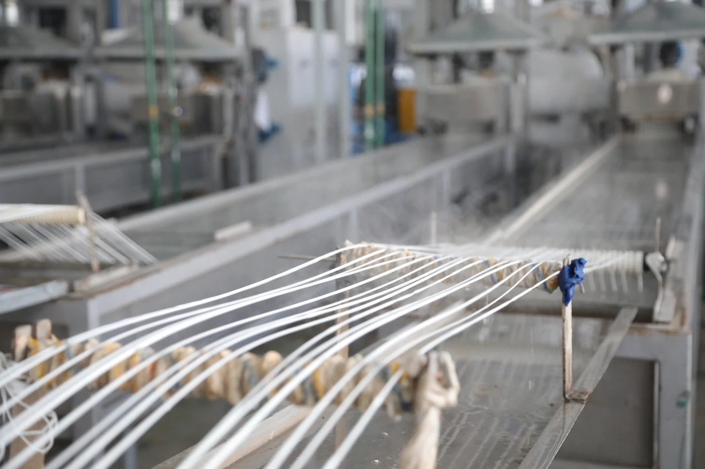 Polyester filaments moving through the production line